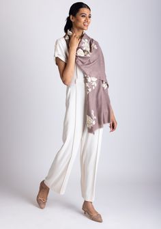 Add a touch of elegance to your wardrobe with our copper cashmere scarf, featuring bold floral embroidery in striking two-tone beige and ivory. The rich copper hue beautifully complements the intricate floral design, making it a standout accessory. Crafted from luxuriously soft cashmere, this scarf provides warmth and comfort, while the delicate eyelash fringes add a refined, textured finish. Whether styled casually or for a special occasion, this exquisite piece effortlessly enhances any outfit Elegant Beige Scarves For Festive Season, Elegant Silk Pashmina Shawl With Intricate Embroidery, Elegant Silk Shawl With Chikankari Embroidery, Elegant Cream Scarves For Festive Season, Elegant Chikankari Embroidery Shawl, Elegant Pashmina Scarf With Resham Embroidery, Elegant Festive Scarf With Resham Embroidery, Elegant Beige Shawl With Resham Embroidery, Elegant Beige Pashmina Shawl With Intricate Embroidery