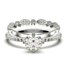 a white gold engagement ring set with a round brilliant diamond surrounded by pave diamonds