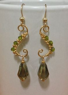 gold plated earrings with green crystal beads and spirals on the earwires