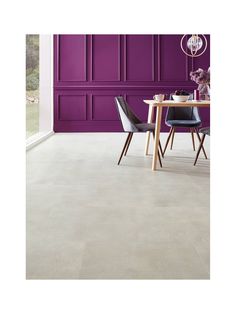 a dining room with purple walls and chairs