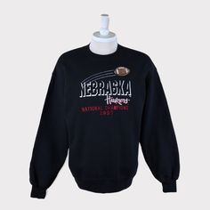 Embroidered Vintage 1997 National Champions Nebraska Cornhuskers (University of Nebraska-Lincoln) Football/Basketball NCAA Sweatshirt 💯 SATISFACTION AND AUTHENTICITY ⭐ MEASUREMENTS (when laid flat) Size on Tag: L Length: 71cm or 28 inches Armpit to armpit: 58cm or 23 inches ⭐ CONDITION 9/10 (Very good) Details: No holes Material: Cotton Color: Black Brand: NAS 🔷 Please give us your phone no. together with address after you purchased. 🔷Please keep in mind that our items are vintage so they may Throwback Long Sleeve T-shirt For College, College Sports Season Crew Neck Hoodie, Crew Neck Hoodie With Embroidered Logo For College, Throwback Crew Neck Hoodie For Game Day, Casual Sweatshirt With Embroidered Logo For Fans, Casual Sweatshirt With Embroidered Graphics For Fans, Sports Season Embroidered Sweatshirt For Streetwear, Collegiate Crew Neck Hoodie For Sports Season, Varsity Sweatshirt With Embroidered Logo For Fans