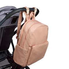 a backpack strapped to the back of a stroller