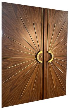 two wooden doors with metal handles on each side and sunbursts in the middle