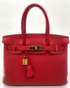 >>PRE OWNED<< >> FOR SALE << Authentic HERMÈS Birkin 30 Togo Lipstick Red Calf Leather Gold Hardware Handbag Dimensions: Height - 8.5" Length - 12" Depth - 6" Condition Description: Bag is in Very Good, Used Cosmetic Condition, There are Very Few Light but Visible Black Stains in Front of the Bag, There are Some Light, but Visible Scratches on Hardware from Normal Use, Interior is in Very Good, Used Cosmetic Condition, There are Some Very Light, But Visible Stain Spots from Normal Use. Overall Handbag is in Very Good Cosmetic Condition. ITEM COMES EXACTLY AS PICTURED NO OTHER ITEMS/ACCESSORIES ARE INCLUDED BESIDES THE ONES STATED IN DESCRIPTION AND SHOWN IN PICTURES! Attention!!!  As a precautionary measure to prevent fraudulent activity we will no longer accept bids or offers from account Cheap Red Bags With Gold-tone Hardware, Affordable Red Bags With Gold-tone Hardware, Red Satchel Bag With Gold-tone Hardware, Luxury Red Bag With Gold-tone Hardware, Red Leather Bag With Gold-tone Hardware, Hermes Birkin 30, Black Stains, Gold Hardware, Bags Handbags