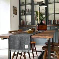 a dining room table with chairs and a book shelf in the backround area