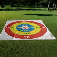 a large white and red target on top of green grass