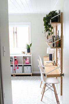 a room with a desk, chair and bookshelf