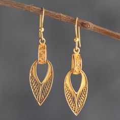 Peru's Alfredo Inga employs the expertise that comes from decades of work to create these beautiful dangle earrings. The earrings are crafted from 24k gold-plated sterling silver filigree. Yellow Gold Pendant Earrings For Pierced Ears, Ceremonial Yellow Gold Drop Earrings, Gold Plated Pendant Earrings With Intricate Design, Gold Plated Filigree Teardrop Jewelry, Teardrop-shaped Gold Plated Filigree Jewelry, Ceremonial Pierced Drop Earrings, Ornate 22k Gold Earrings With Intricate Design, Elegant 22k Gold Danglers As Gift, Elegant 22k Gold Danglers For Gift