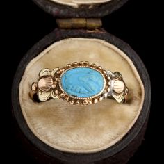 This ring was a commitment jewel. The fede motif (two clasped hands) represents the joining of hands of the couple at a marriage ceremony, a practice that dates back to ancient Rome and was known as 'dextrarum iunctio'. This fede is turquoise-colored glass, pressed in the Georgian era and set into a tricolor gold mounting with shell and flower details at the shoulders. MATERIALS: blue glass, 14k tricolor gold (tests). AGE: c. 1800 SIZE: size 6.5, can be resized; 8.4mm head, 1.3mm shank Ancient Yellow Gold Jewelry For Ceremonial Occasions, Ancient Style Yellow Gold Jewelry For Ceremonial Occasions, Ancient Style Yellow Gold Ceremonial Jewelry, Ancient Ceremonial Hallmarked Jewelry, Ancient Ceremonial Jewelry, Ceremonial Oval Cabochon Rings, Antique Adjustable Rings With Intricate Design, Victorian Engraved Rings For Marriage, Antique Ceremonial Ring With Intricate Design