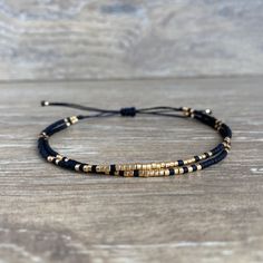 A delicate and elegant string bracelet made of two strands of black and gold miyuki beads. ☆ ☆ ☆ SIZING☆ ☆ ☆ This bracelet is easily adjustable thanks to a macrame slide knot. It should fit most adults and teens but please message me if you think you need a smaller or larger fit. It is about 5 inches when fully tightened and about 9 inches when expanded. ☆ ☆ ☆ TAKING CARE OF YOUR BRACELET ☆ ☆ ☆ This bracelet is NOT waterproof. If you want to retain its original qualities over time, please remove Chip Jewelry, Bracelet Styles, Miyuki Bracelet, Black Beaded Bracelets, Cord Jewelry, Pola Gelang, Diy Bracelet Designs, Gelang Manik, Beads Bracelet Design