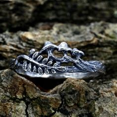 a silver ring sitting on top of a rock