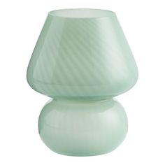 a light green vase sitting on top of a white table