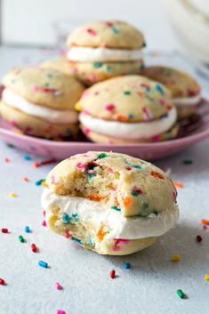 a plate full of ice cream sandwiches with sprinkles