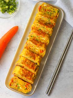 an omelet with vegetables and chopsticks next to it