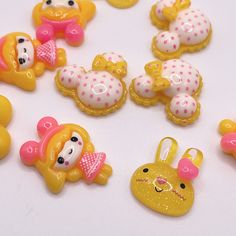 there are many plastic toys that look like bears and rabbits on the table together,