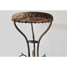 an ornate iron table with roped ends