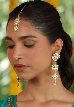 Make a luxurious statement with these 22k gold plated earrings with kundan maang tikka. The intricate design is crafted from shimmering gold and encrusted with delicate kundan stone, creating an exquisite look of opulence and sophistication. Perfect for adding a touch of glamour to any ensemble. Details : Package Includes: Choose from drop-down menu : Material: Kundan, Gold, Copper : Length: 2.5 inches Care Instruction : Remove your jewelry before showering, swimming, exercising, or participatin Luxury Kundan Tikka, Silver Kundan Earrings For Puja, Temple Jewelry Danglers For Diwali Weddings, Diwali Wedding Temple Jewelry Danglers, Bollywood Style 22k Gold Jhumkas For Wedding, 22k Gold Cutdana Bridal Earrings For Wedding, 22k Gold Cutdana Bridal Earrings, Gold Bridal Earrings With Cutdana For Puja, 22k Gold Meenakari Bridal Earrings For Wedding