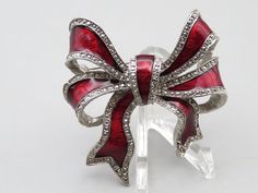 "Beautiful Vintage LG Silver Tone Red Enamel Bow Tie Pin Brooch. The piece is in excellent condition. It is 2\" wide and 1 3/4\" tall. Comes ready to wear. Free Shipping!" Red Enamel Brooch For Gift, Red Enamel Brooch Gift, Red Enamel Brooches For Gift, Red Enamel Brooches As Gift, Vintage Red Enamel Brooches, Red Enamel Vintage Brooch, Vintage Red Brooches For Formal Occasions, Vintage Red Brooches For Party, Vintage Ribbon Brooches As Gift