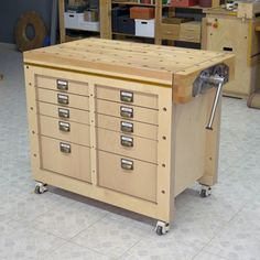 a workbench with many drawers and tools on it