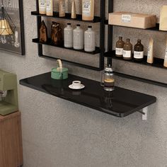 a shelf with bottles and cups on it in front of a wall mounted display case