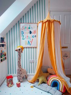 a child's bedroom with a giraffe tent and toys