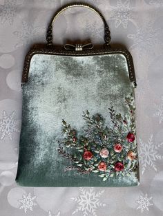 Minty velvet handbag with roses embroidery , velvet handbag, silk roses embroidery,made in our studio  ❤️ *Our handmade rose embroidered minty velvet handbag  *Great gift for yourself or your loved ones.  *romantic piece for girls or women *embroidered with Moulin thread and silk  *Elegant and stylish, unique, one of a kind vintage style velvet handbag is perfect just for you! *Super easy to use  ⁍ I am open to custom orders and personalization.  ⁍You can choose color, size, and flower to embroider and we can embroider monogram as well. ⁍Text us in messages your desires, you can check out our shop for inspiration and ideas. ⚠The color on the photo may be a bit different from the real model, because of the lighting.  Check out the shipping time below ⬇ 🔸Dimensions / ⁍ 24-25Cm Length of the Cheap Vintage Clutch For Party, Luxury Velvet Evening Bag As A Gift, Elegant Green Bag With Floral Embroidery, Elegant Green Bags With Floral Embroidery, Embroidered Velvet Clutch Bag, Embroidered Velvet Rectangular Evening Bag, Handmade Velvet Evening Bags, Rectangular Velvet Wedding Bag, Velvet Rectangular Wedding Bags