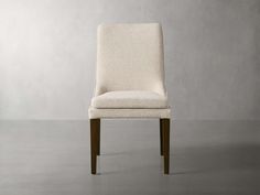 a white chair sitting on top of a gray floor