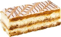 a piece of cake with white frosting and brown lines on the top, sitting in front of a white background