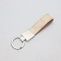 Add some personalized style to your house or car keys. This cute keyring makes the perfect little gift — or gift to self! Material: Genuine Embossed Leather Monogram: The maximum number of letters that can be monogrammed is 7. White Keychain With Key Clip For Gift, White Keychain With Key Clip Gift, Modern Keychain With Key Leash For Gift, Modern Keychain With Key Clip For Gift, Modern Keychain With Key Leash As Gift, Silver Keychain With Key Clip For Gift, Silver Keychain With Key Clip As Gift, Chains Silver, Phone Case Monogram