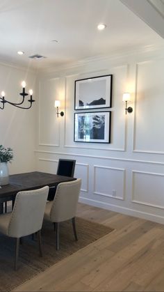 a dining room table and chairs in front of a chandelier