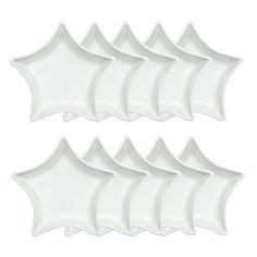 six white plates with wavy designs on each side and one in the middle, all lined up