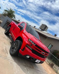 a red truck parked in front of a house