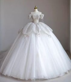 a white wedding dress on display in a room