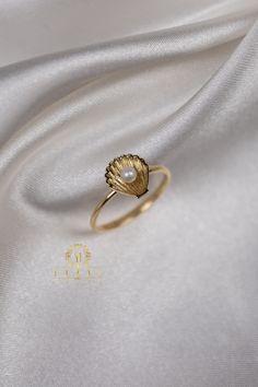 "ABOUT PRODUCT This 14K Gold Seashell Pearl Ring is beautifully designed and hand crafted with our associates to make this a special gift for your loved ones. Knowing the value of our customers, We prepare each piece with extra care and attention.  ITEM DETAILS Material: 14K Gold Approx:  1.50 gram Available colors: Gold, Rose Gold, White Gold Available Sizes:  3 US to 10 US Sizes ✪ 14k Solid Gold ( Certification will be included with your order ) ✪Available 14K White, Yellow, Rose Gold (also in Gold Shell-shaped Ring For Gift, Gold Shell-shaped Gift Ring, Elegant Shell-shaped Ring For Gifts, Stackable 14k Gold Pearl Ring Gift, Handmade 14k Gold Pearl Ring Gift, Pearl Ring Gold, Dainty Gold Ring, Cute Gifts For Her, Gold Pearl Ring