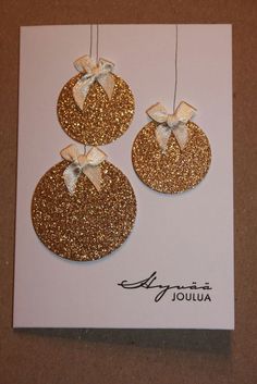 a card with two gold glittered circles and bows