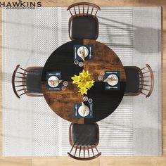 an overhead view of a dining room table with four chairs and a yellow flower in the center