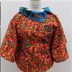 African Print  Top, Women's Blouse  100% Cotton Dimensions:  Length: approximately 22 inches long from top of shoulder to midriff                           SIZEBUSTWAIST 14          42           36 16          44           38 18          46           40 20          48           42 This item features bold, beautiful colors  Simple, elegant, laid back style perfect for easy Summer dressing Simply slip over your head and go!  Wear with jeans,fitted pencil skirt or trousers Care Instructions: Can be Hand washed. Dry Clean recommended. Do not use bleach. Handmade.  Made to order. This is a loose fitting blouse and is designed to hang on the body Fitted Foldover Top Blouse For Summer, Fitted Printed Cropped Blouse, Printed Fitted Cropped Tops, Fitted Cropped Printed Blouse, Fitted Cropped Printed Tops, Fitted Collared Printed Tops, Casual Fitted Blouse With Foldover Top, Fitted Casual Blouse With Foldover Top, Padded Short Sleeve Fitted Blouse