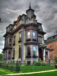 an old victorian style house on a cloudy day