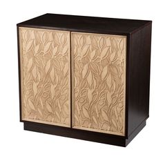 a wooden cabinet with carved leaves on it