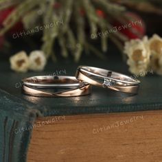 two wedding rings sitting on top of a book