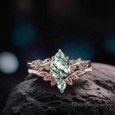 a close up of a ring on top of a rock with leaves and stones in the background