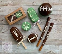 chocolate covered candies with football decorations on them and cupcakes in the background