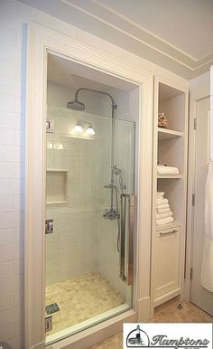 a walk in shower sitting inside of a bathroom