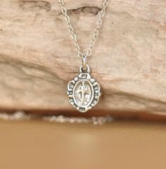 Virgin mary necklace - sterling silver virgin mary necklace - religious necklace A tiny sterling silver virgin mary hangs on a 16 inch sterling silver chain. Please feel free to select a different length chain if you prefer! This beauty is also available in gold vermeil. This little beauty measures 9mmx7mm More from BubuRuby? https://www.etsy.com/shop/BubuRuby?ref=hdr_shop_menu Looking for other charm necklaces? https://www.etsy.com/shop/BubuRuby?section_id=12318467 More crystals and healers? ht Sterling Silver Charm Necklace With Oval Pendant, Spiritual Sterling Silver Necklace With Miraculous Medal, Dainty Silver Charm Necklace With Oval Pendant, Silver Cross Jewelry With Miraculous Medal, Dainty Miraculous Medal Charm Necklace As Gift, Dainty Miraculous Medal Charm Necklaces As Gifts, Dainty Necklace With Miraculous Medal, Dainty Charm Necklaces With Miraculous Medal For Gifts, Sterling Silver Miraculous Medal Jewelry