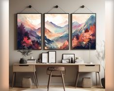 two paintings on the wall above a desk