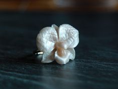 "This delicate white pearl orchid ring is made from polymer clay with special cover. ALL BASES ARE ADJUSTABLE ;  silver plated base 6.5-8.5/ 16.9-18.5 mm 925 sterling silver adjustable base 5.5-8/ 15.9-18 mm or 7-9  gold plated sterling silver 925  base 5.5-8 us/15.9-18 mm or 7-9  925 silver base 4.5-8 us Large Orchid sizes about 28*28 mm/ 1,1*0,98 inch Small orchid size about  18*18 mm/0,7*0,7\" Also I have bases with other adjustable sizes (6-8 size in gold, silver and bronze colors). If you need other base for this rose just let me know and I create it for you PEARL ROSE RING: https://www.etsy.com/listing/464029122/pearl-ring-polymer-clay-ring-pearl-rose?ref=shop_home_active_16 The ring is adjustable and can fit any size by gently pushing together the ends, overlapping them or gently pu Unique White Flower Ring, Elegant Handmade White Flower Ring, Fimo Ring, Orchid Ring, Clay Silver, Silver Rose Ring, Polymer Clay Ring, Rose Gold Plated Ring, Ring Pearl