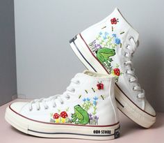 "Experience the art of hand embroidery on Converse embroidered shoes, a testament to meticulous craftsmanship." Custom embroidery converse/Frog and mushroom embroidered shoes/ Custom embroidered converse high tops/Frog nad mushroom embroidery sneakers  💸 Price includes Converse Shoes and floral embroidery as shown 🌸 You can send me your Converse/Vans shoes or I can buy them for you. We stock all the Converse and Vans shoes you want, if you want other Converse/Vans shoes in the store, please me Embroidery On Converse, Embroidered Converse High Tops, Converse Shoes High Top, Embroidery Converse, Frog And Mushroom, Mushroom Embroidery, Shoe Painting, Painted Converse