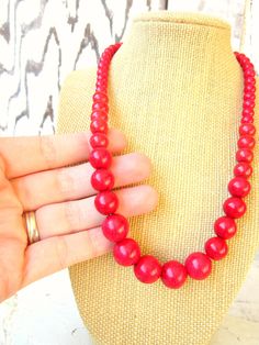 "Simply stunning red. This graduated necklace is made from red howlite semi precious stones. The stones range in size from 14mm - 5mm. Choose from a lobster claw closure or a toggle closure. The lobster claw closure will have a 2\" extender chain the toggle closure will be a fixed length. Find matching EARRINGS here: https://www.etsy.com/shop/JensBeadBox?section_id=10618715&ref=shopsection_leftnav_5 See more of my handmade jewelry here: https://www.etsy.com/shop/JensBeadBox?ref=shopsection_s Red Wooden Beaded Necklaces, Red Wooden Beaded Necklace, Red Necklace With Wooden Beads, Red Wooden Beads Round Necklace, Red Coral Beaded Necklace With Wooden Beads, Red Necklaces With 8mm Beads For Jewelry Making, Red 8mm Bead Necklace, Red Wooden Beaded Necklaces As Gifts, Red Wooden Beaded Necklaces For Gifts