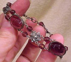 An Edwardian Czech purple faceted glass silver plated bracelet circa 1910 1920. This vintage 7" length bracelet has amethyst-purple glass faceted, to look like gems. It has oval and round stones and ornate silver plated flower seggments in between. It is not marked, but Czechoslovakia was not a separate country from the Austro-Hungarian empire until 1919. It closes with a (replaced) spring-ring clasp, and it is in otherwise excellent vintage condition with no chips, cracks, scrapes, dents, monog Silver Plated Bracelet, Dope Jewelry, Purple Crystal, Jewelry Lookbook, Funky Jewelry, Amethyst Purple, Purple Glass, Girly Jewelry, Faceted Glass