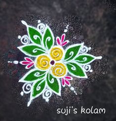 an artistic design on the ground with words saying suji's kolam written below